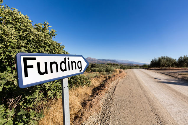 road sign post reads Funding